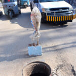 A view of open sewerage manhole on Qazi Qaiyoum Road