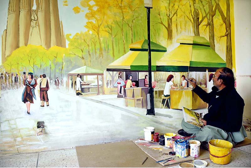 Artist busy in making wall paintings in front of the MM Alam Road