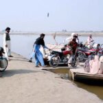 Old boats in very dilapidated condition are being used to provide transport facility to people as well as to motorcycles to cross river water of Sutlej River in suburb of the city.