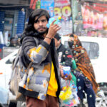 A street vendor displaying and selling bubble guns for kids at Clock Tower Chowk