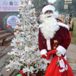 A student wearing a Santa Claus get-up during a program in connection with Christmas at Shalimar Garden