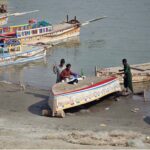 Fishermen paint their boat at Indus River