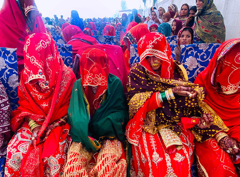Grooms and brides during a mass marriage ceremony held in a local garden, organized by the Odero Lal Welfare Association. A total of 250 couples participated, including 125 Muslims and 125 Non-Muslims