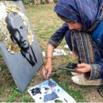 Participant giving final touches to the painting during the event in connection with 147th birth anniversary of Quaid-e-Azam Muhammad Ali Jinnah