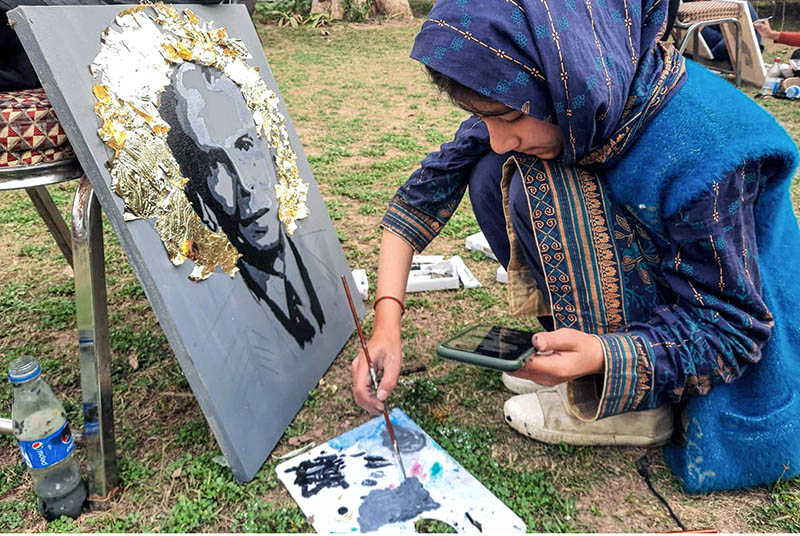 Participant giving final touches to the painting during the event in connection with 147th birth anniversary of Quaid-e-Azam Muhammad Ali Jinnah