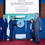 Caretaker Prime Minister Anwaar-ul-Haq Kakar strikes the Gong to mark the launch of Government Sukook Auction at Pakistan Stock Exchange.