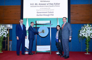 Caretaker Prime Minister Anwaar-ul-Haq Kakar strikes the Gong to mark the launch of Government Sukook Auction at Pakistan Stock Exchange.