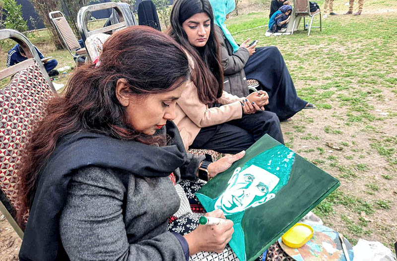 Participant giving final touches to the painting during the event in connection with 147th birth anniversary of Quaid-e-Azam Muhammad Ali Jinnah
