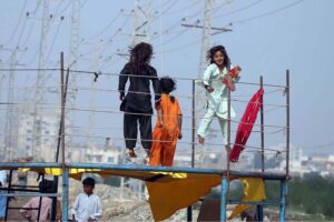 Children enjoy jumping on the trampoline at Qasimabad