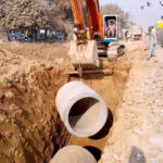 Heavy machinery being used to expand roads during development work in the city