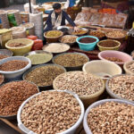 A vendor selling dry fruit at his roadside setup.