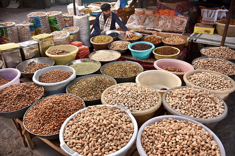 A vendor selling dry fruit at his roadside setup.