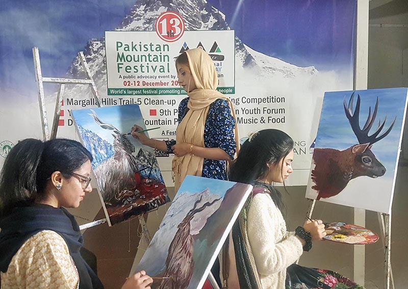 Students busy in painting mountain ecosystems in a competition at the Punjab Arts Council organized by Devcom-Pakistan and Snow Leopard Foundation in connection with 13th Pakistan Mountain Festival