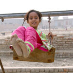 A girl enjoying swing at Rahmatpur near Railway Station