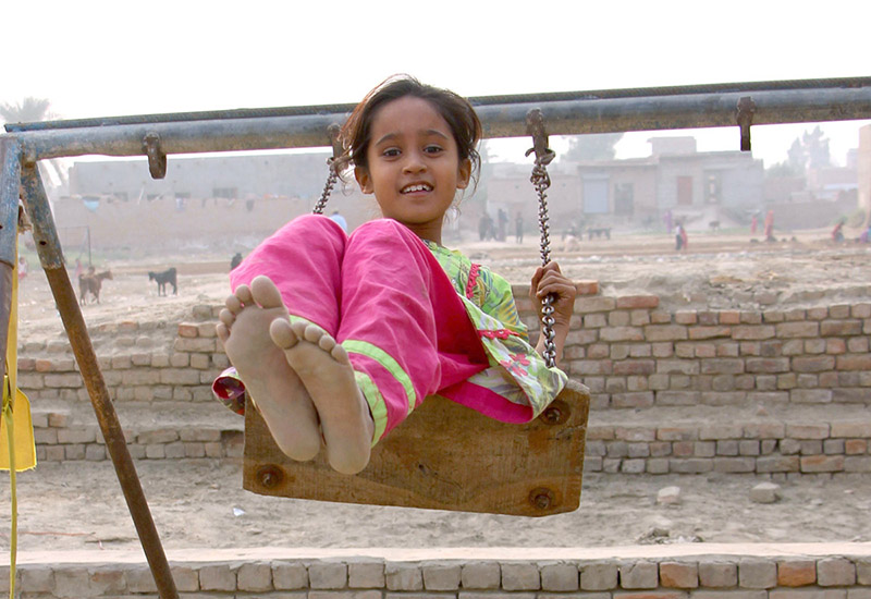 A girl enjoying swing at Rahmatpur near Railway Station