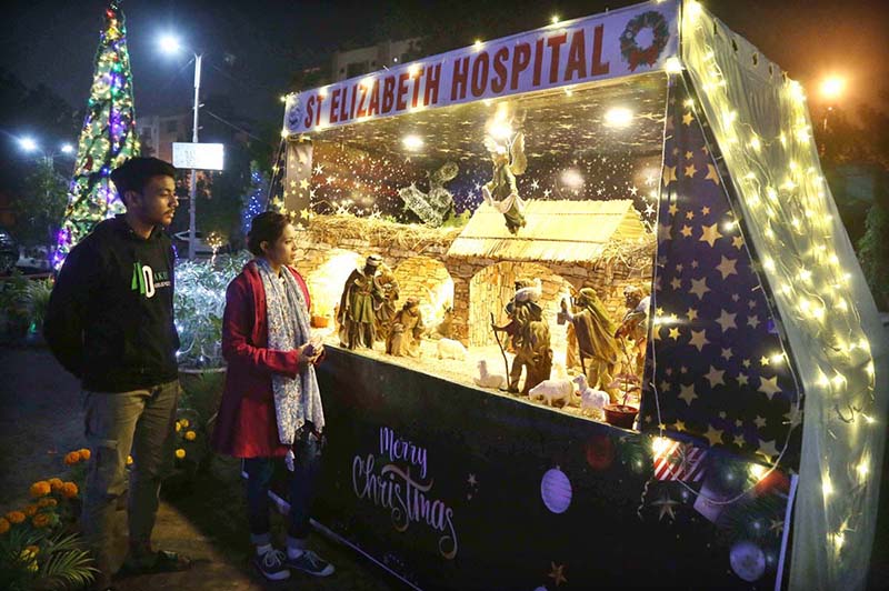 Christian couple viewing the imagery hovering at St. Elizabeth hospital in preparation of Christmas celebrations