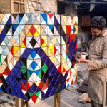 Artist finalizing his artwork on the color box at his shop