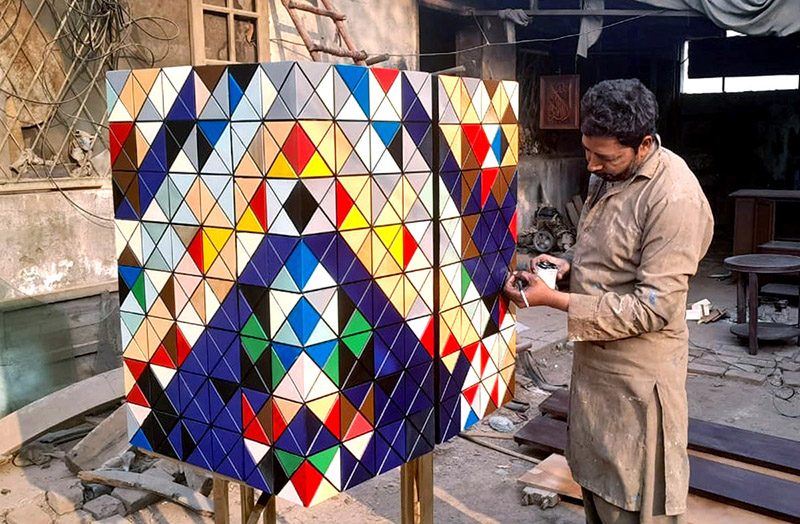 Artist finalizing his artwork on the color box at his shop