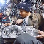 Youngster busy in repairing vehicle headlight at Shoba Bazar.
