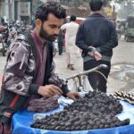 A vendor displaying Sangara to attract the customers on his bi-cycle in a local market