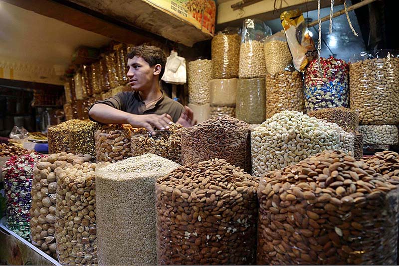 Vendor displaying dry fruits to attract the customers at bacha khan chowk