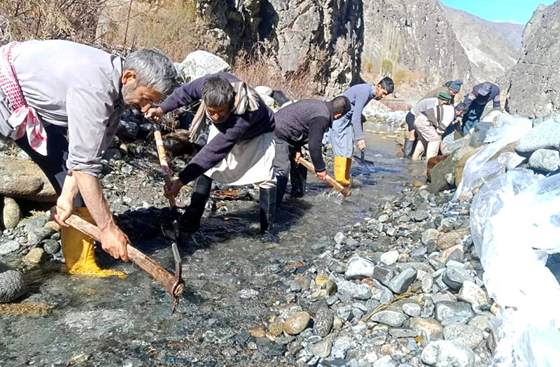Water and Power staffer busy in diverting water to the power house for the smooth supply of power in city