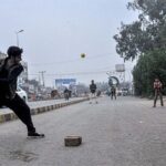 Youngster playing traditional game at Azadi Chowk
