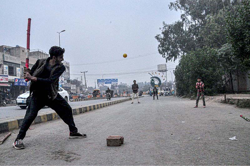Youngster playing traditional game at Azadi Chowk