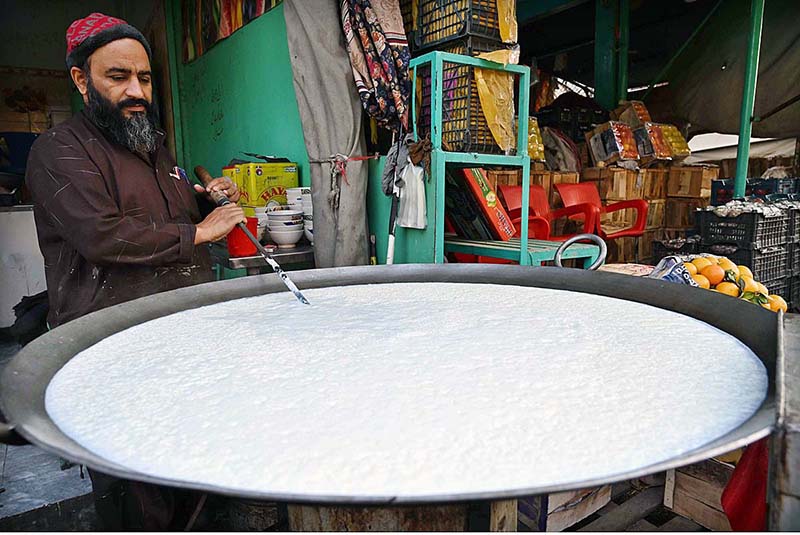A vendor busy boiling milk at his shop