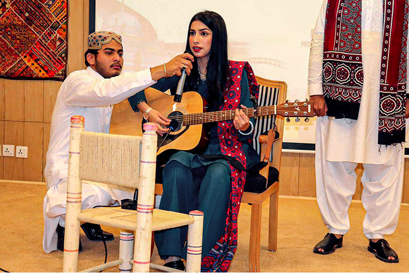 A student singing cultural song during Sindhi Culture and Heritage Day by Haseeb Ahmad Chairman Sindhi Sangat at SZABIST