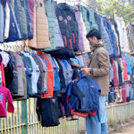 Vendor displaying Jackets to attract customers at roadside setup