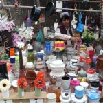 A vendor displaying the crockery items to attract the customer at Makki Shah Road