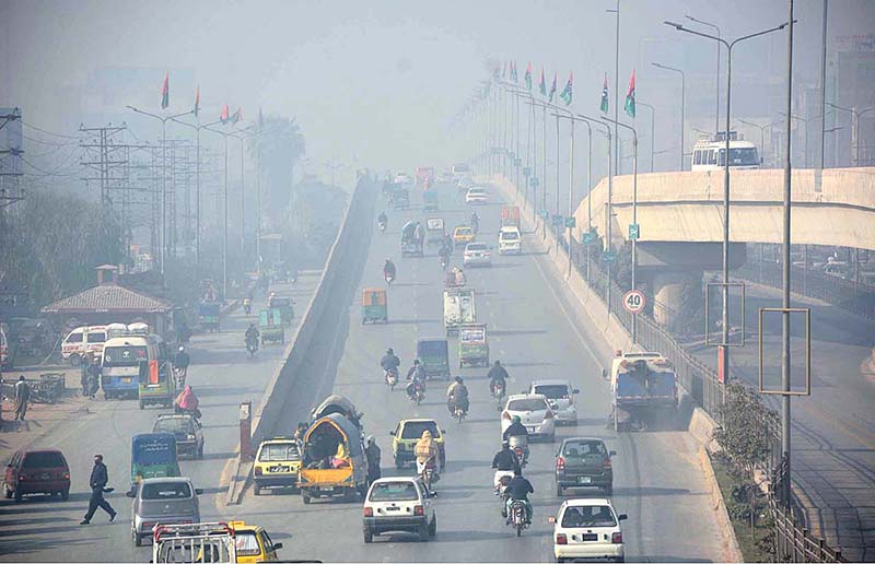 Vehicles on the way as thick fog that engulfs the whole city during morning time