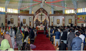 Christian community members performing religious rituals on Christmas Day at Catholic Church Railway Road.