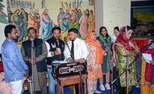 Christian community members performing religious rituals on Christmas Day at Catholic Church Railway Road.