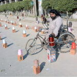 A disable vendor displays thermos to attract the customer at his roadside setup