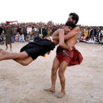 Wrestlers in action during traditional wrestling (Mulakhat) in front of Dargah Mian Shahul Muhammad Kalhoro during annual urs celebrations at Ghazi Khan Khuhawar Village