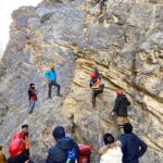 Rescue 1122 officials practicing rock climbing on the mountain.