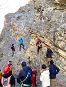 Rescue 1122 officials practicing rock climbing on the mountain.