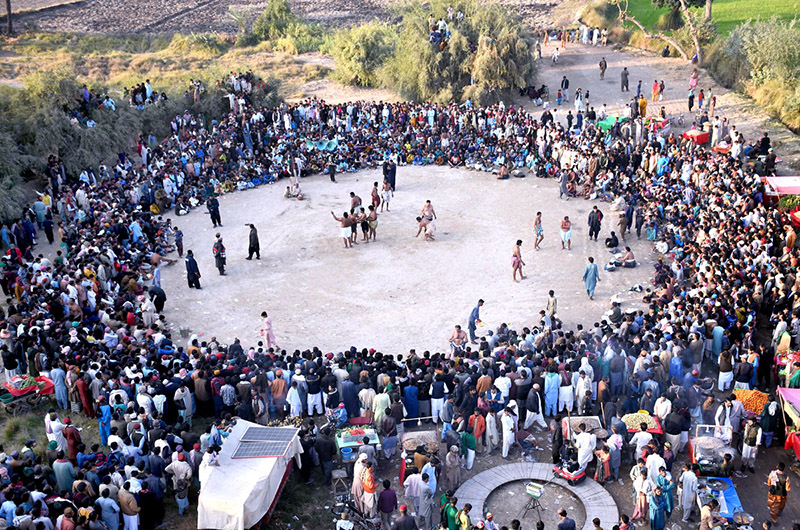 Wrestlers in action during traditional wrestling (Mulakhat) in front of Dargah Mian Shahul Muhammad Kalhoro during annual urs celebrations at Ghazi Khan Khuhawar Village
