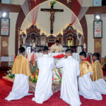 Christian community members performing religious rituals on Christmas Day at Catholic Church Railway Road.