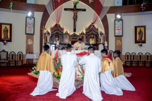 Christian community members performing religious rituals on Christmas Day at Catholic Church Railway Road. 