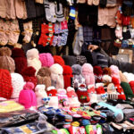A vendor selling and displaying different warm stuff at local market