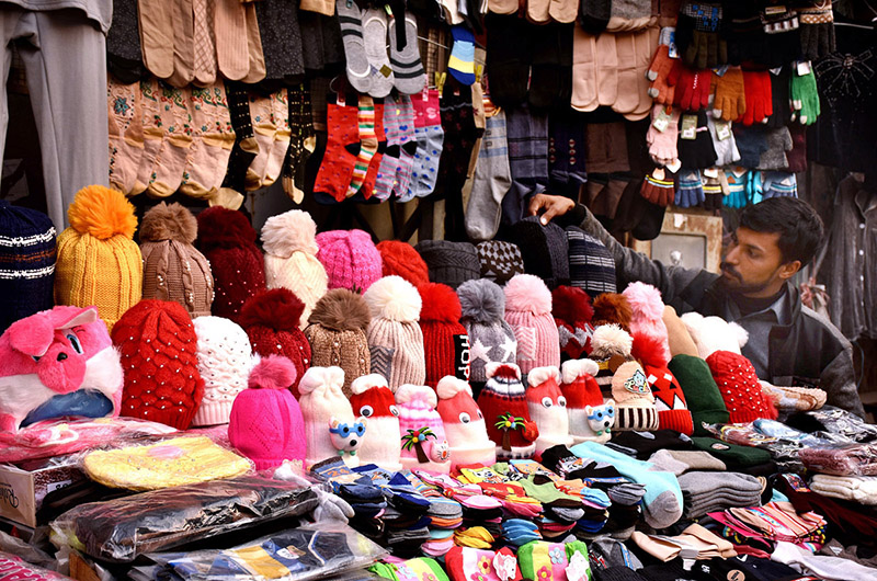 A vendor selling and displaying different warm stuff at local market