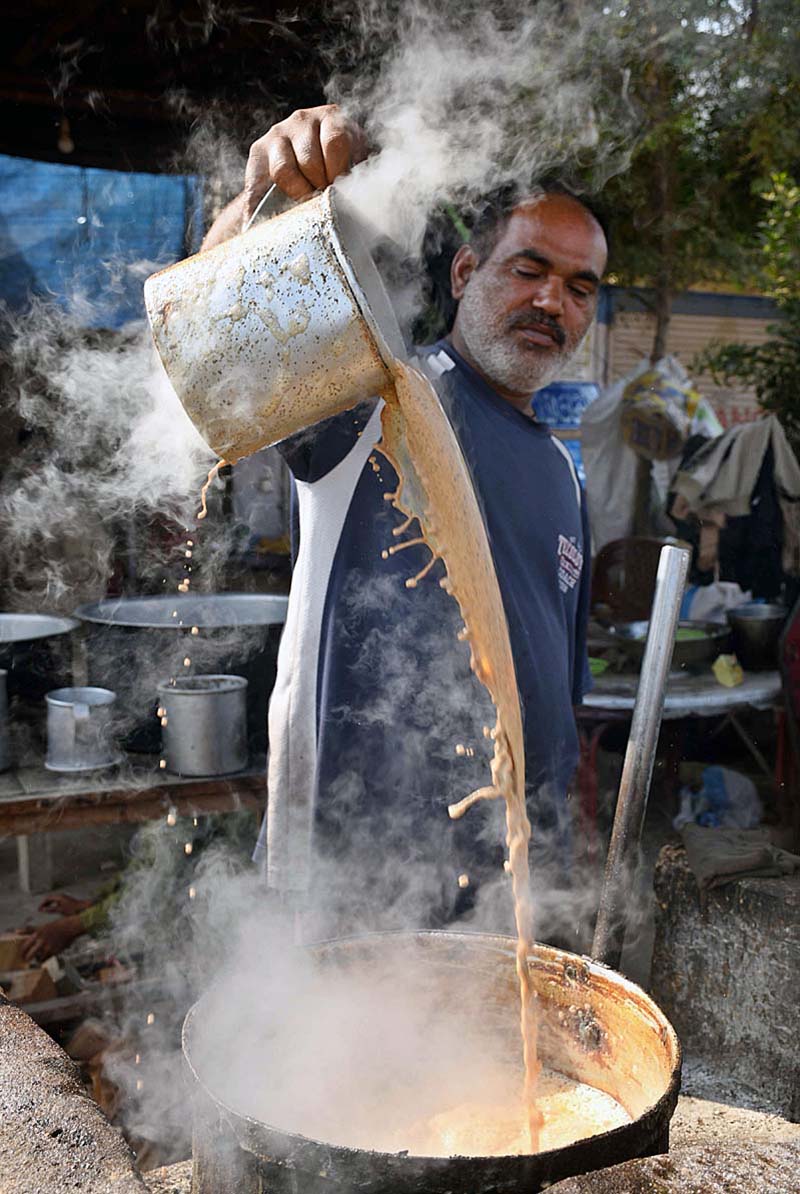 A worker making tea for customers at hotel near New Bus Stand Road