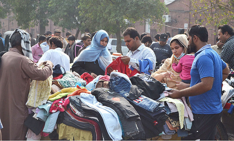 People selecting and purchasing second hand warm clothes at Landa Bazar on the beginning of winter season in the Provincial Capital