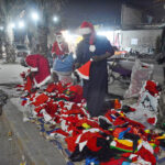 A vendor selling Santa Claus dress at a roadside stall ahead of Christmas