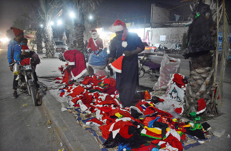 A vendor selling Santa Claus dress at a roadside stall ahead of Christmas