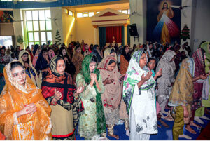 Christian community members performing religious rituals on Christmas Day at Catholic Church Railway Road.