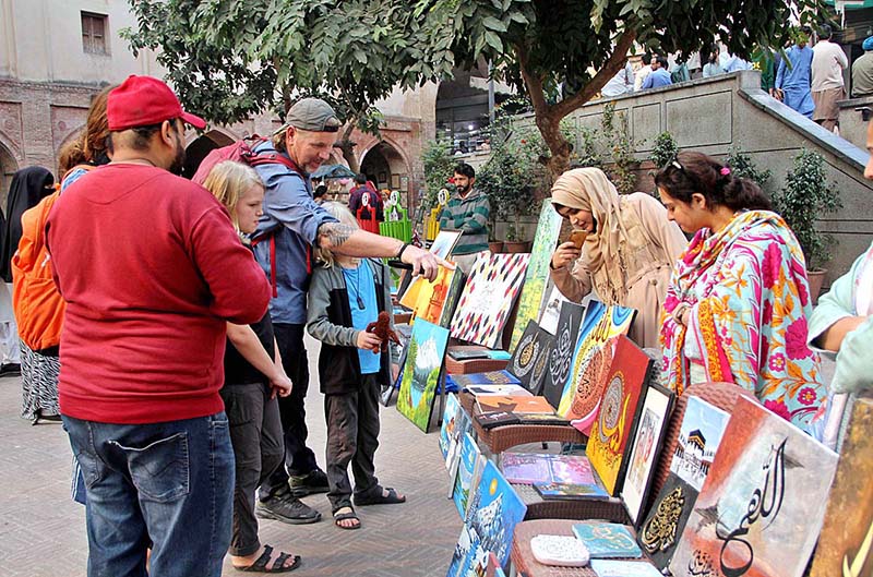 People viewing Painting exhibition organized by Bab-e-Pakistan Foundation and Walled City Authority at Wazir Khan Mosque Delhi Gate